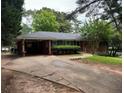 Single story brick home featuring an attached carport and mature landscaping at 4188 Fontana Ct, Tucker, GA 30084