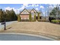 Attractive two-story home with a well-maintained lawn, mature trees, and a charming mailbox, creating a welcoming curb appeal at 5245 Wilshire Xing, Cumming, GA 30040