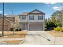Beautiful two-story home with gray siding, a two-car garage, and a well-manicured front yard at 110 Centennial Ridge Dr, Acworth, GA 30102