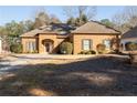 Charming brick home with well-maintained lawn, classic shutters, and a welcoming front porch at 570 Mcgarity Dr, Mcdonough, GA 30252