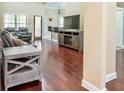 Open living room with hardwood floors, neutral walls, and modern furniture arrangement at 570 Mcgarity Dr, Mcdonough, GA 30252