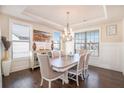 Elegant dining room featuring hardwood floors, wainscotting and modern chandelier at 2435 Portsmouth Ct, Marietta, GA 30064