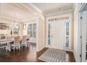 Inviting foyer with hardwood floors and a view into the dining room featuring a chandelier and natural light at 2435 Portsmouth Ct, Marietta, GA 30064