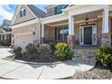 Welcoming front entrance with stone accents, landscaped garden, and covered porch at 2435 Portsmouth Ct, Marietta, GA 30064