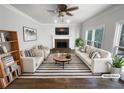 Bright living room featuring a fireplace, hardwood floors, and neutral furniture at 2925 Chesterfield Se Way, Conyers, GA 30013