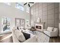 Bright living room featuring a fireplace, tall windows, and a decorative accent wall at 742 Eastwood Rise, Stone Mountain, GA 30087