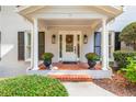 Inviting front porch featuring brick steps, a decorative door, and manicured landscaping at 870 Richmond Hill Dr, Marietta, GA 30068