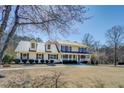 Inviting two-story home with metal roof and a picturesque front yard at 1103 Wallington Nw Ct, Conyers, GA 30012
