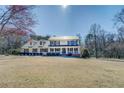 Beautiful home featuring a metal roof, a welcoming front porch, and a spacious front lawn at 1103 Wallington Nw Ct, Conyers, GA 30012