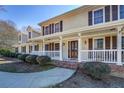 Charming front porch with white railings and a beautifully crafted wooden door at 1103 Wallington Nw Ct, Conyers, GA 30012