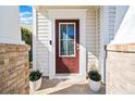Inviting front door with glass panel, flanked by brick pillars and decorative potted plants at 113 Plumeria St, Canton, GA 30114