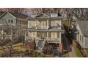 Attractive two-story home with a porch, second story balcony, well-manicured landscaping, and mature trees at 970 Drewry Ne St, Atlanta, GA 30306