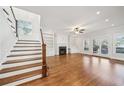 Inviting living room with wood floors, built-in shelving, fireplace, and staircase access at 970 Drewry Ne St, Atlanta, GA 30306