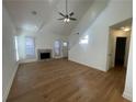 Open living room featuring hardwood floors, a stone fireplace, and plenty of natural light at 1039 Whitfield Se Ct, Smyrna, GA 30080