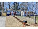 Quaint home with a concrete driveway and steps leading up to the property at 2767 3Rd Sw Ave, Atlanta, GA 30315