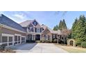 Elegant two-story home with a stone facade, attached garage, arched entry and landscaped front yard at 2813 Long Grove Ct, Marietta, GA 30062