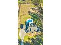 An aerial view of a stunning home with a luxurious pool and expansive grounds at 650 New Morn Dr, Hampton, GA 30228