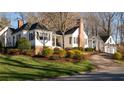 Beautifully landscaped white home with manicured lawn and tasteful plantings surrounding the property at 255 Maple Nw Ave, Marietta, GA 30064