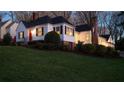 Charming two-story home with a red door, black shutters, and manicured landscaping at 255 Maple Nw Ave, Marietta, GA 30064