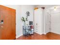 Inviting hallway with a decorative coffee bar, storage cabinet, and wood flooring, providing a warm welcome at 361 17Th Nw St # 1610, Atlanta, GA 30363