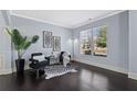 Sitting room with dark floors, large window, black chairs, and striking black and white rug at 3845 Alden Place, Cumming, GA 30028