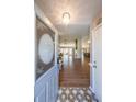 Inviting foyer with decorative tile and chandelier leading into an open-concept living space at 403 Flint Hill Ct, Lawrenceville, GA 30044