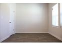 Bedroom with wood-look flooring, a large window, and neutral paint at 625 Egrets Landing #49, Covington, GA 30014