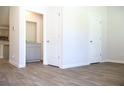 Spacious living room features neutral walls, light gray cabinets, and wood-look flooring at 625 Egrets Landing #49, Covington, GA 30014