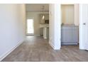 Open-concept living room with light gray walls, wood-look flooring, and neutral color palette at 625 Egrets Landing #49, Covington, GA 30014