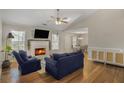 Inviting living room with a fireplace, hardwood floors, and vaulted ceiling at 3540 Traddsprings Way, Snellville, GA 30039