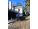 Charming two-story home with a light-colored exterior and well-maintained landscaping at 1 Willowick Dr, Lithonia, GA 30038