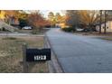 A street view of the neighborhood, featuring the house's mailbox with the address clearly displayed at 3129 Rock Pine Way, Snellville, GA 30078