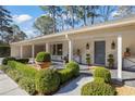 Inviting front entrance with lush landscaping, a covered porch, and a modern blue door at 2034 Eldorado Ne Dr, Atlanta, GA 30345