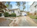 View of house and driveway with detached garage and fenced in yard at 2107 Old Dallas Sw Rd, Marietta, GA 30064