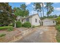 View of a one story home with a long driveway leading to a detached two car garage at 2107 Old Dallas Sw Rd, Marietta, GA 30064