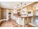 Bright kitchen with wood island, white cabinetry, and hardwood floors leading to a living area at 2107 Old Dallas Sw Rd, Marietta, GA 30064