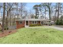 Well-maintained brick home with a lush lawn and a convenient carport at 3245 Westmart Ln, Atlanta, GA 30340