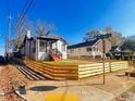 Desirable home featuring a freshly painted exterior and new wooden fence surrounding the property at 1074 Hobson Sw St, Atlanta, GA 30310