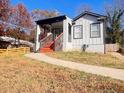 Beautiful home featuring orange steps, modern railings, brick accents, and a sidewalk at 1074 Hobson Sw St, Atlanta, GA 30310