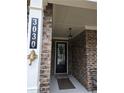 Close-up of the home's front door with a covered porch at 3030 Appling Hills Dr, Dacula, GA 30019