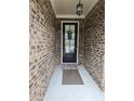 The front door is framed by a stylish brick facade at 3030 Appling Hills Dr, Dacula, GA 30019