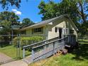 Exterior view of building featuring yard, ramp, and mature tree landscaping at 3941 Covered Bridge Sw Rd, Smyrna, GA 30082