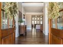 Elegant foyer showcasing hardwood floors, decorative wreaths, and an open view to the living spaces beyond at 5175 Wilshire Xing, Cumming, GA 30040