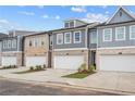 A row of townhouses shows exteriors with brick, siding, and 2-car garages at 1068 Rose Dr, Marietta, GA 30060