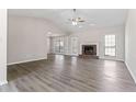 Spacious living room with vaulted ceilings, fireplace, neutral paint, and modern laminate wood floors at 1295 Brady Ct, Hampton, GA 30228