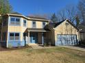 Charming two-story home featuring an attached two-car garage and freshly manicured landscaping at 2615 Fox Hall Ln, Atlanta, GA 30349