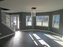 Bright living room with gray walls, wood floors, and ample natural light from large windows at 2615 Fox Hall Ln, Atlanta, GA 30349