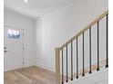 Bright foyer features light wood floors and an elegant staircase with black iron railings at 488 Hammons Way, Atlanta, GA 30315