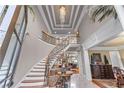 Grand foyer with a curved staircase, decorative iron railing, marble floors, and elegant trim at 2679 Wynnton Dr, Duluth, GA 30097