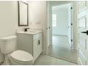 Clean and modern half bath showcasing a white vanity with a black faucet and a view into a light-filled bedroom at 1514 Gatekeeper Ter, Marietta, GA 30066